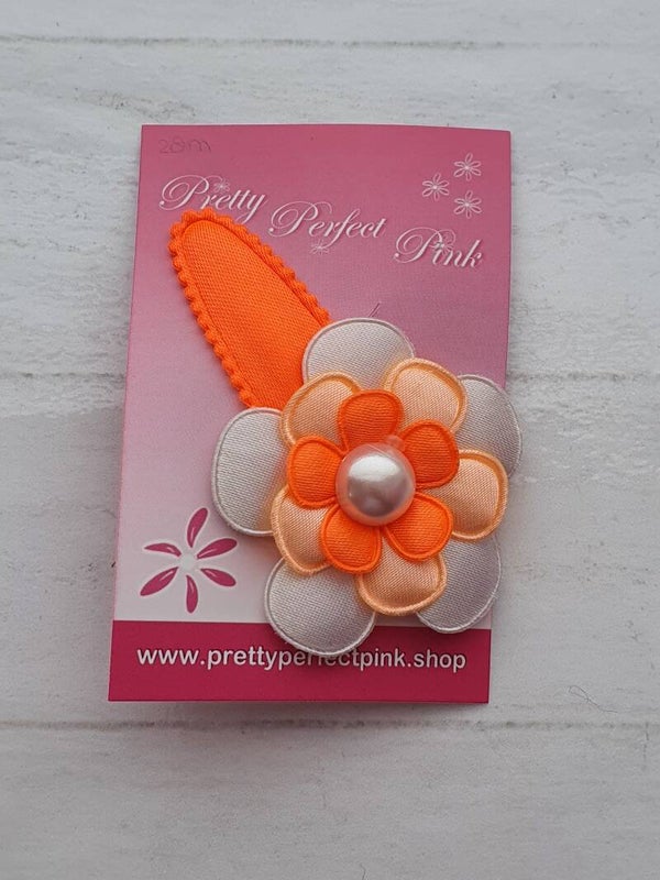 Neon oranje haarspeld met bloem
