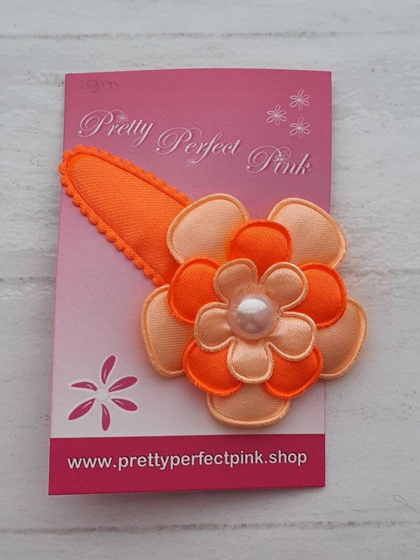 Neon oranje haarspeld met bloem