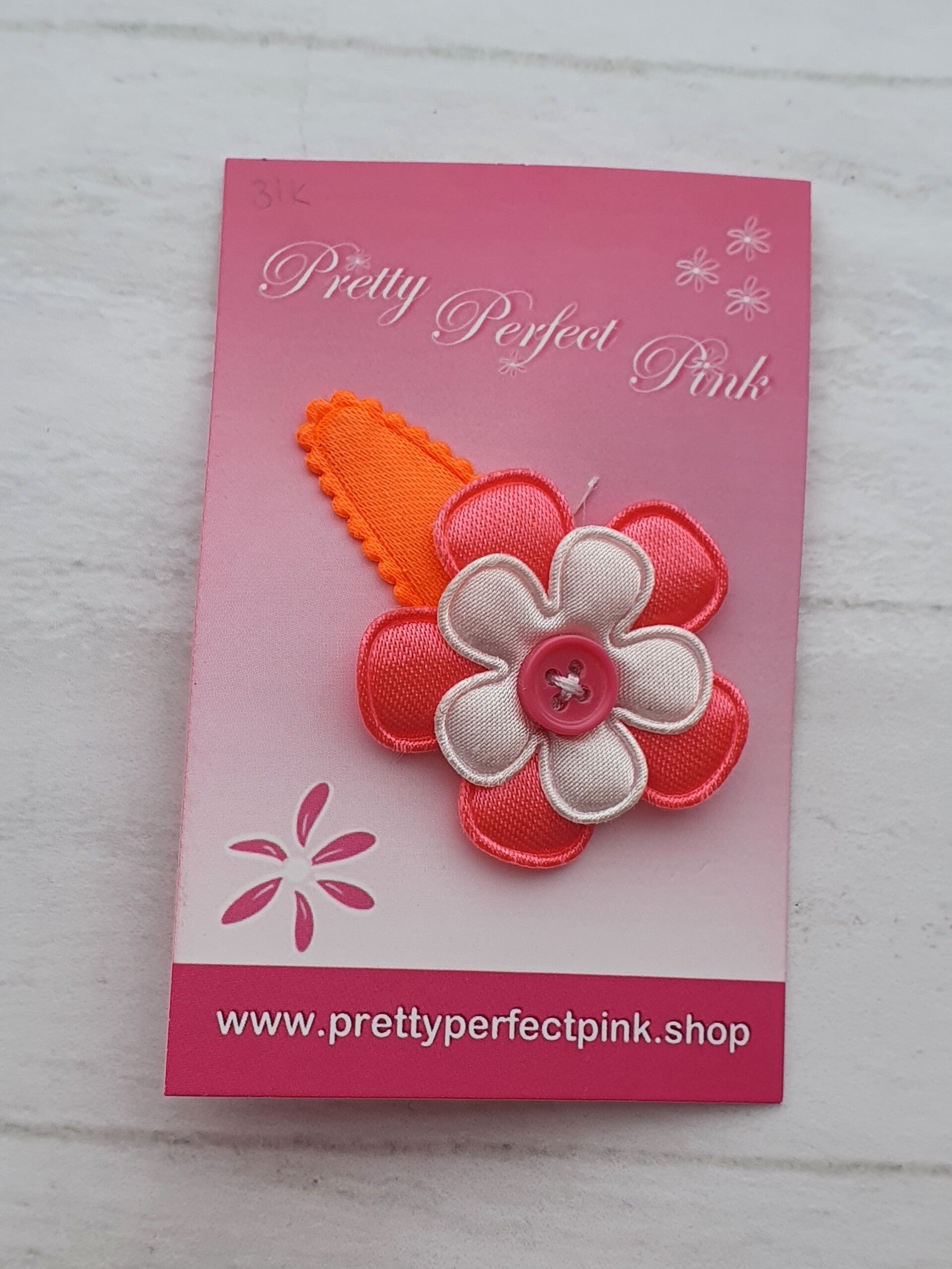 Neon oranje haarspeldje met bloemetjes