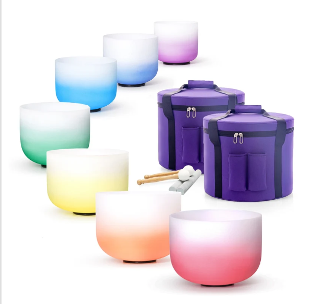 Luxury 7 chakra crystal singing bowl set in radiant rainbow colors with purple carrying cases, mallets, and accessories for meditation and sound healing.