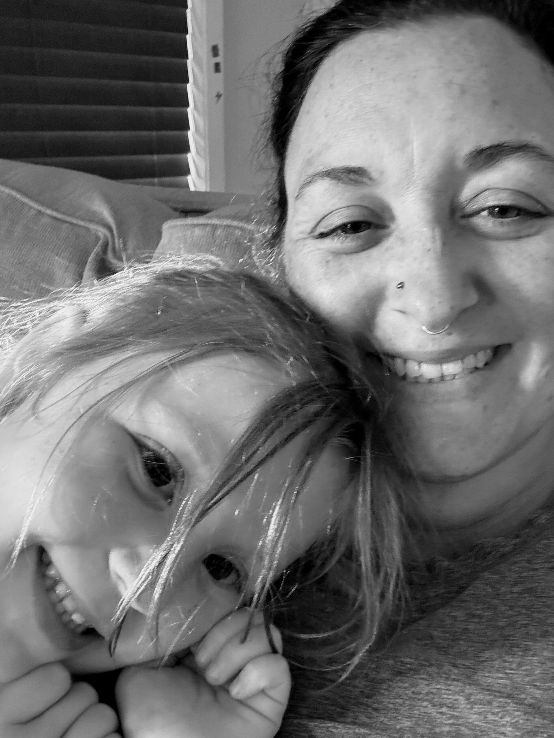 Megan, Christian doula and childbirth educator at The Motherhood Calling, smiling with her daughter — inviting mothers to book a free virtual call to learn about faith-based birth support and natural birth guidance.