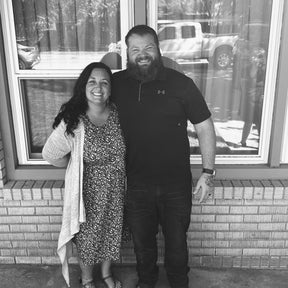 Megan, founder of The Motherhood Calling, Christian doula and childbirth educator, smiling with her husband — offering faith-based virtual doula support, natural birth education, and Christ-centered encouragement for mothers.
