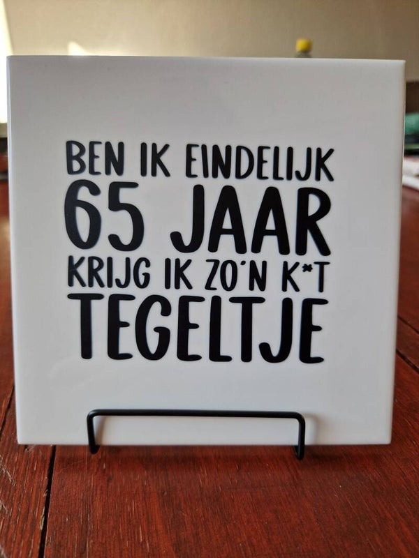 Ben ik eindelijk 65 jaar, krijg ik zo'n kut tegeltje Tegeltje