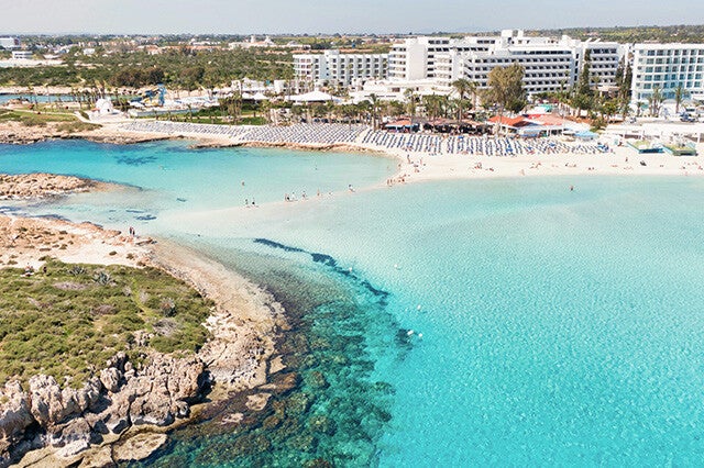 Crystal clear turquoise waters and golden sands in Ayia Napa and Protaras, a stunning destination for your beach day trip transfer.