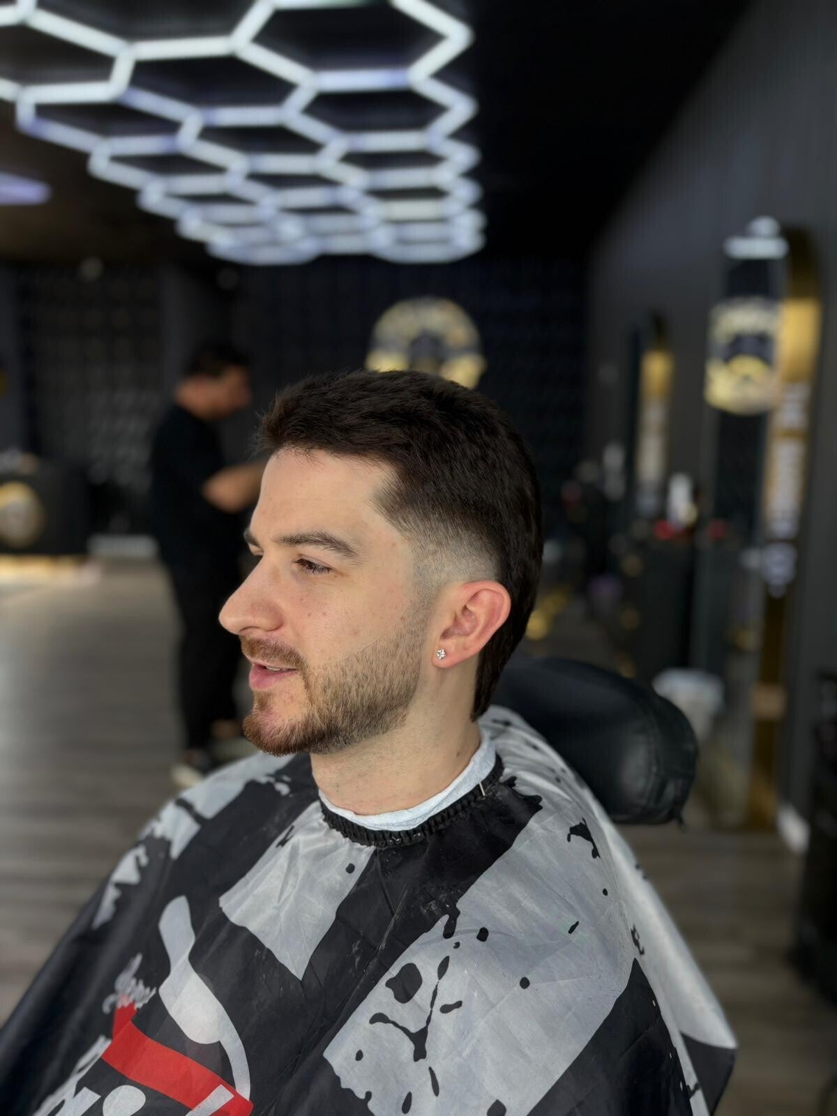 Mid-skin fade haircut with sharp lineup by The Barber Co. in Windsor, Ontario