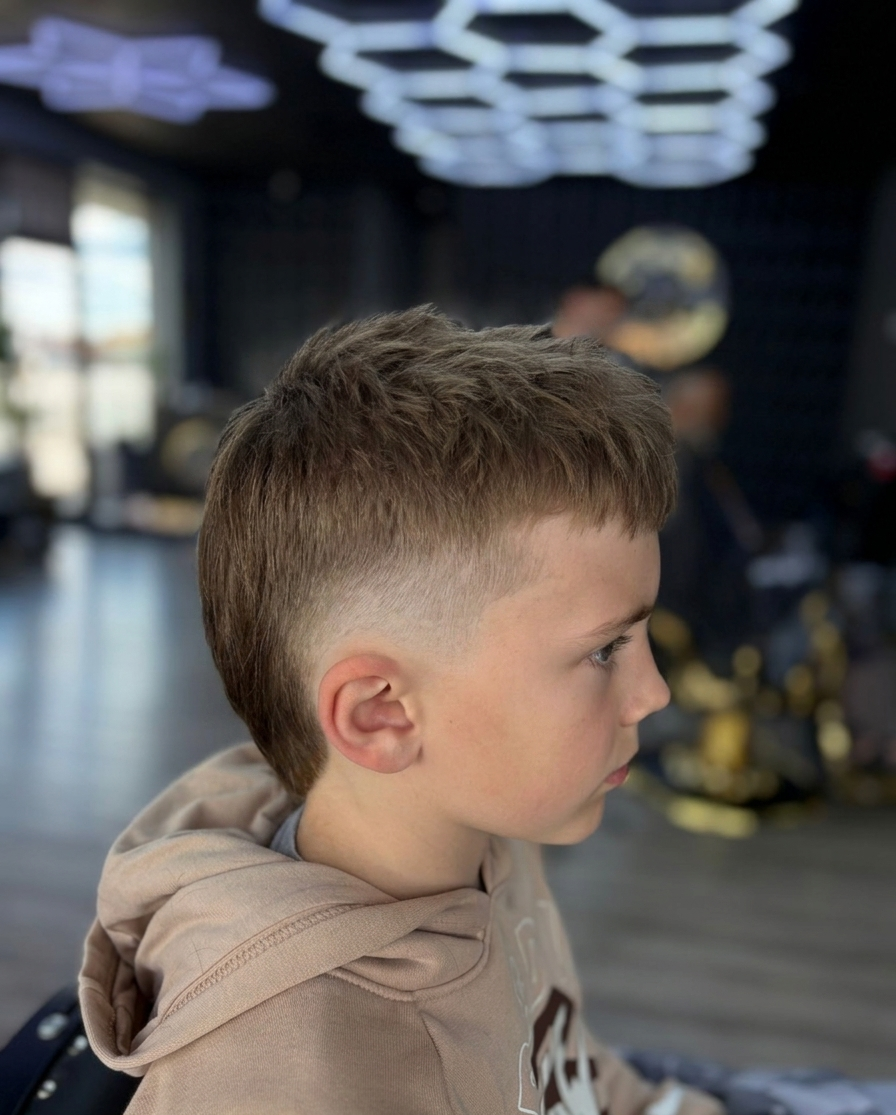 Modern mullet haircut for kids at THE BARBER CO in Windsor, Ontario. a clean low taper fade at The Barber Co.