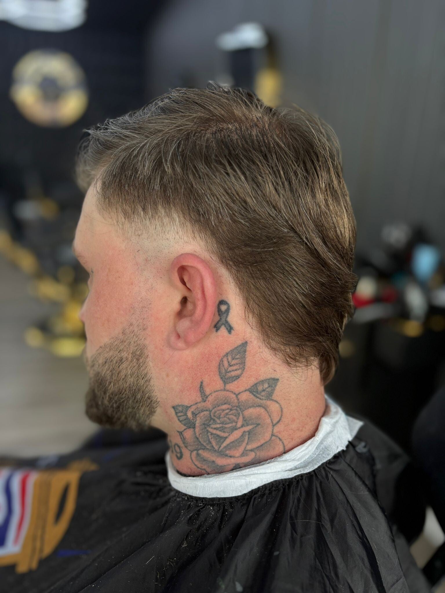 Side view of a modern mullet haircut and sharp beard trim with a precision taper fade at a Windsor, Ontario barber shop.