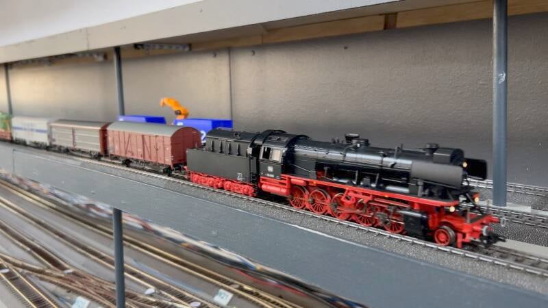 Stoomlocomotief met een sleep goederenwagons.