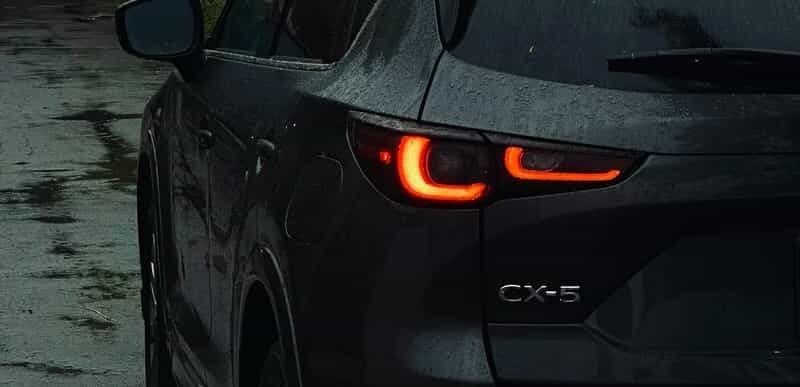 Rear view of a Mazda CX-5 in rainy Brisbane driveway – pre-purchase car inspection in progress