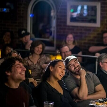 Crowd laughing at a comedy show