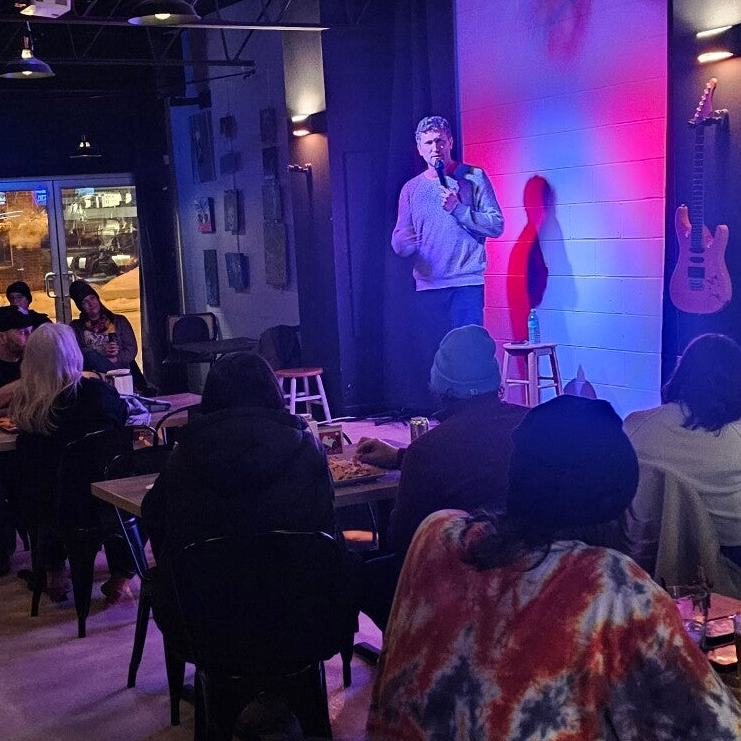 Crowd laughing at a comedy show