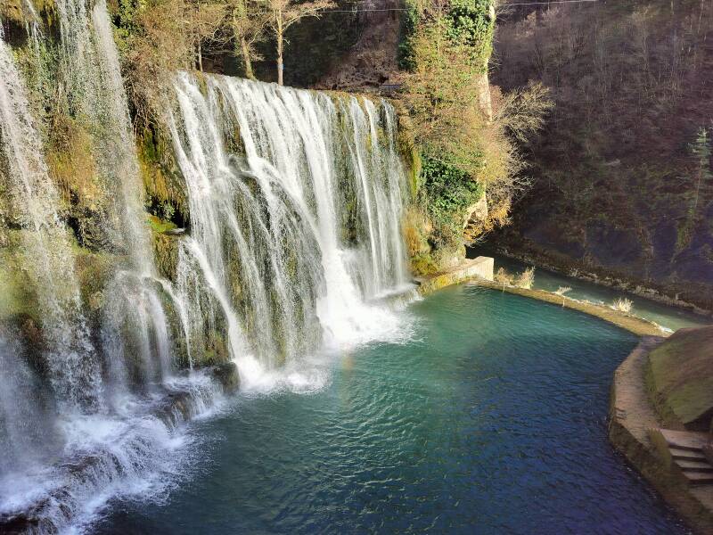 Powerful Pliva Waterfall crashing into a turquoise basin in the heart of Jajce.