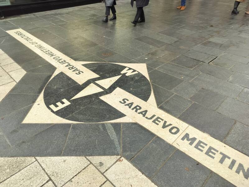 Meeting of Cultures" marker in Sarajevo showing the divide between East and West architectural influences.