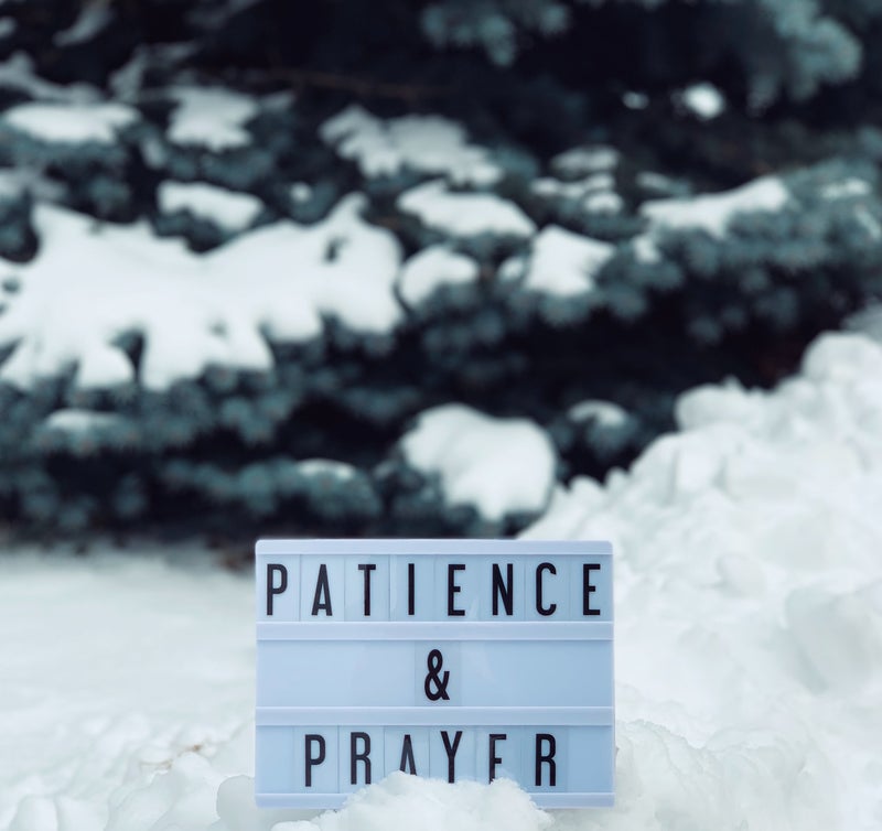 patience and prayer sign in the snow