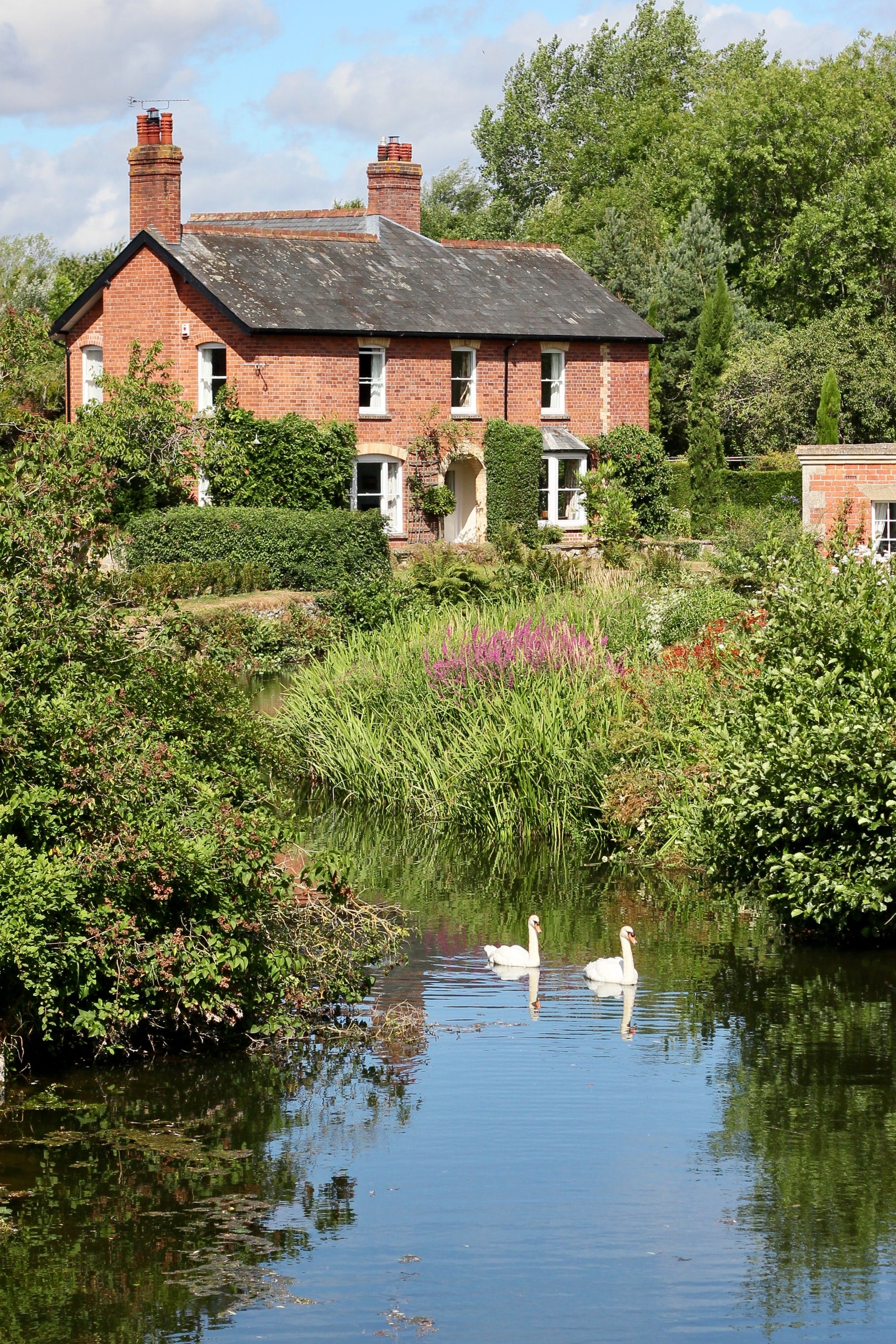 Country cottage by a stream with swans — discreet home care.